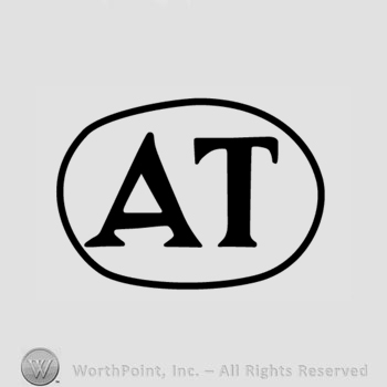 The text ''AT'' in a circle.