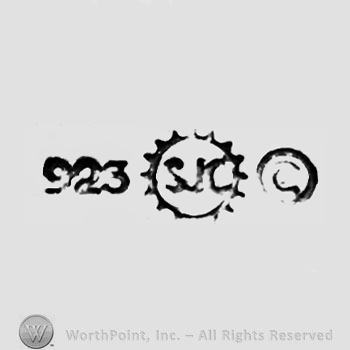 The numbers ''923'', the monogram of the letters ''S'', ''J'' and ''C'' in a sun and the letter''c'' in a circle.