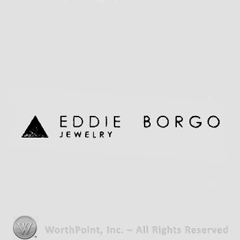 A triangle and the text ''Eddie Borgo Jewelry''.