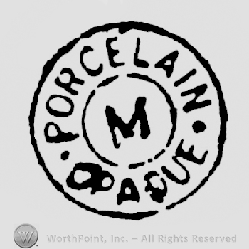 Porcelain written arched above an M in a circle, above Opaque written arched, all inside a circle shape frame