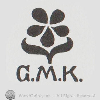 a flower above "GMK"