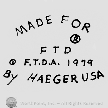 Curved writing above Made for, R inside a small circle above FTD, F.T.D.A. 1979 written under, By Haeger USA written on the bottom