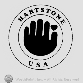 Image of a hand and a heart above, inside a circle, Hartstone written above, USA written under, inside the larger circle