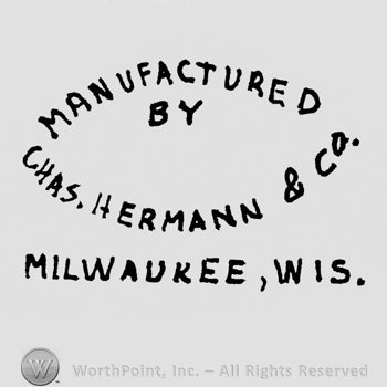Written in shape of a circle: Manufactured above, By in the middle, Chas. Hermann & Co on the bottom, Milwaukee, Wis. Written under