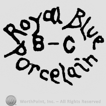 B-C written in the center. Above is written Royal Blue, under is written Porcelain. The writings form a circle