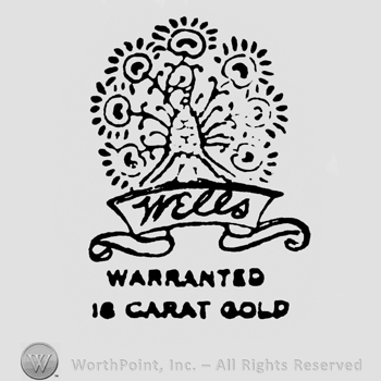 A peacock above. Ribbon under on which is written: Wells. Warranted 16 Carat Gold written under.