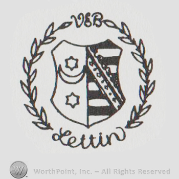 Shield with crescent moon and two start, stripes on the right, all inside a round branches design, uppercase V&B above and handwritten Lettin below