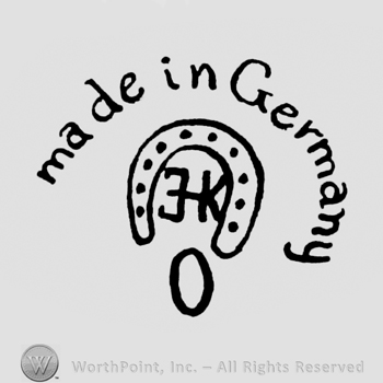 a horseshoe and the text Made in Germany above; 0 written bellow.