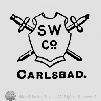 Shield with two swords behind and letters SW Co written on; CARLSBAD written bellow.