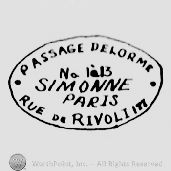 an oval logo with the name and adress of the company: PASSAGE DELORME SIMONNE PARIS RUE DE RIVOLIM