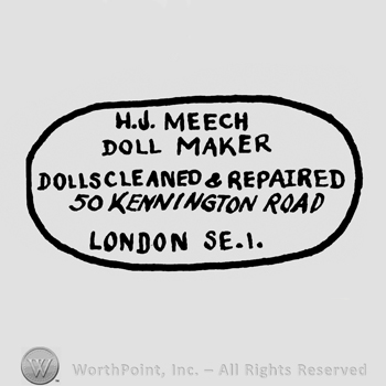 an oval design with the name and adress of the company: HJ MEECH DOLL MAKER DOLSCLEANED & REPAIRED 50 KENNINGTON ROAD LONDON.
