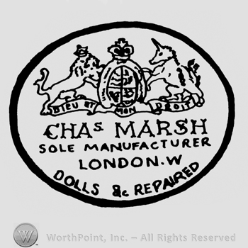 an oval sign with a lion an an unicorn inside; CHA MARSH SOLE MANUFACTURER LONDON DOLLS REPAIRED written bellow.