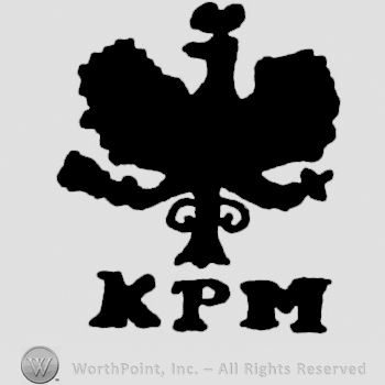 a crowned eagle above the initials KPM