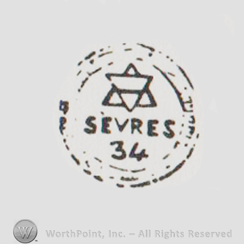 Sevres 34 written with uppercase letters next to David's star inside a double-lined circle