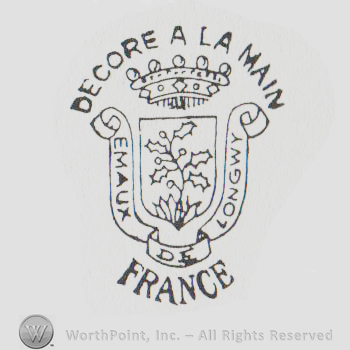 Shield with plant, crown above and ribbons on sides, Emaux Longwy written with uppercase letters on the ribbons, Decore A La Main France written outside the logo with uppercase letters
