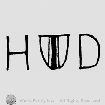 A shield between the initials H D.