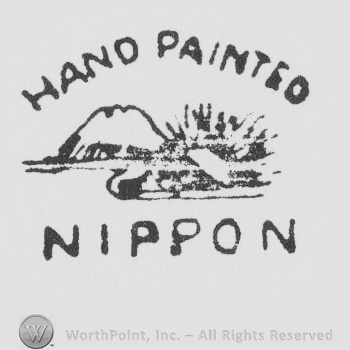 A volcano, Mt. Fujiyama with the words Hand Painted and NIPPON written above and below with uppercase letters 