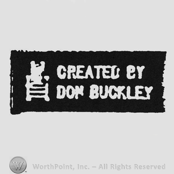 White chair and writing Created by Don Buckley on a black label