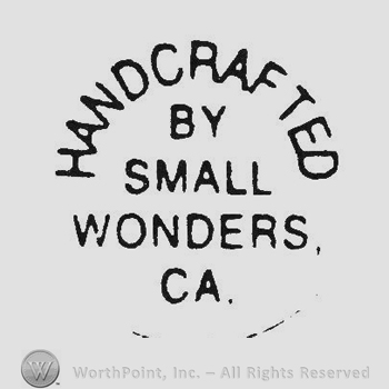 Capital writing Handcrafted up By Small Wonders Ca. under
