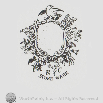 shield shaped ornamented logo with a bird with spread wings above