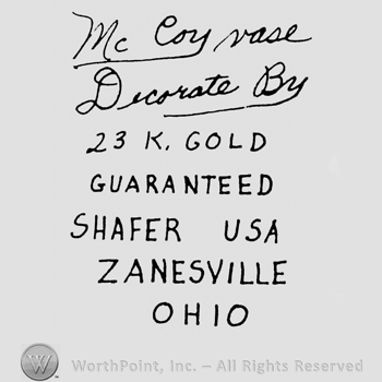 Mc Coy Vase hand written above Decorate By hand written above  23 K. Gold written above Guaranteed written above Shafer USA written above Zanesville written above Ohio
